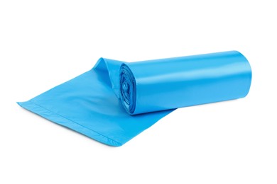 Photo of Roll of turquoise garbage bags on white background. Cleaning supplies