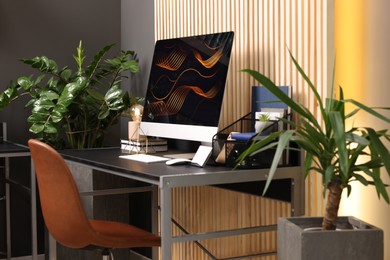 Photo of Cozy workspace with computer on metal desk at home