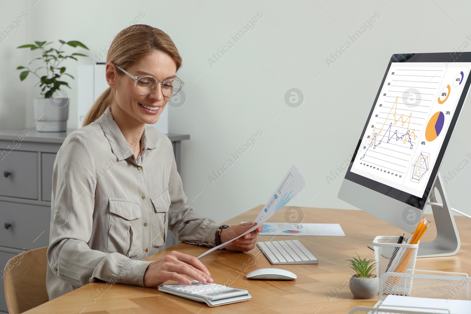 Photo of Professional accountant working at wooden desk in office