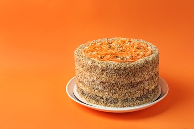 Photo of Dish with delicious carrot cake on color background. Space for text