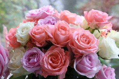 Photo of Beautiful bouquet of aromatic roses outdoors, closeup