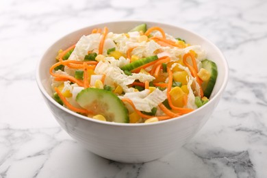 Photo of Tasty salad with Chinese cabbage, carrot, corn and cucumber in bowl on white marble table