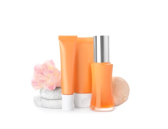 Cosmetic products, flower and spa stones on white background