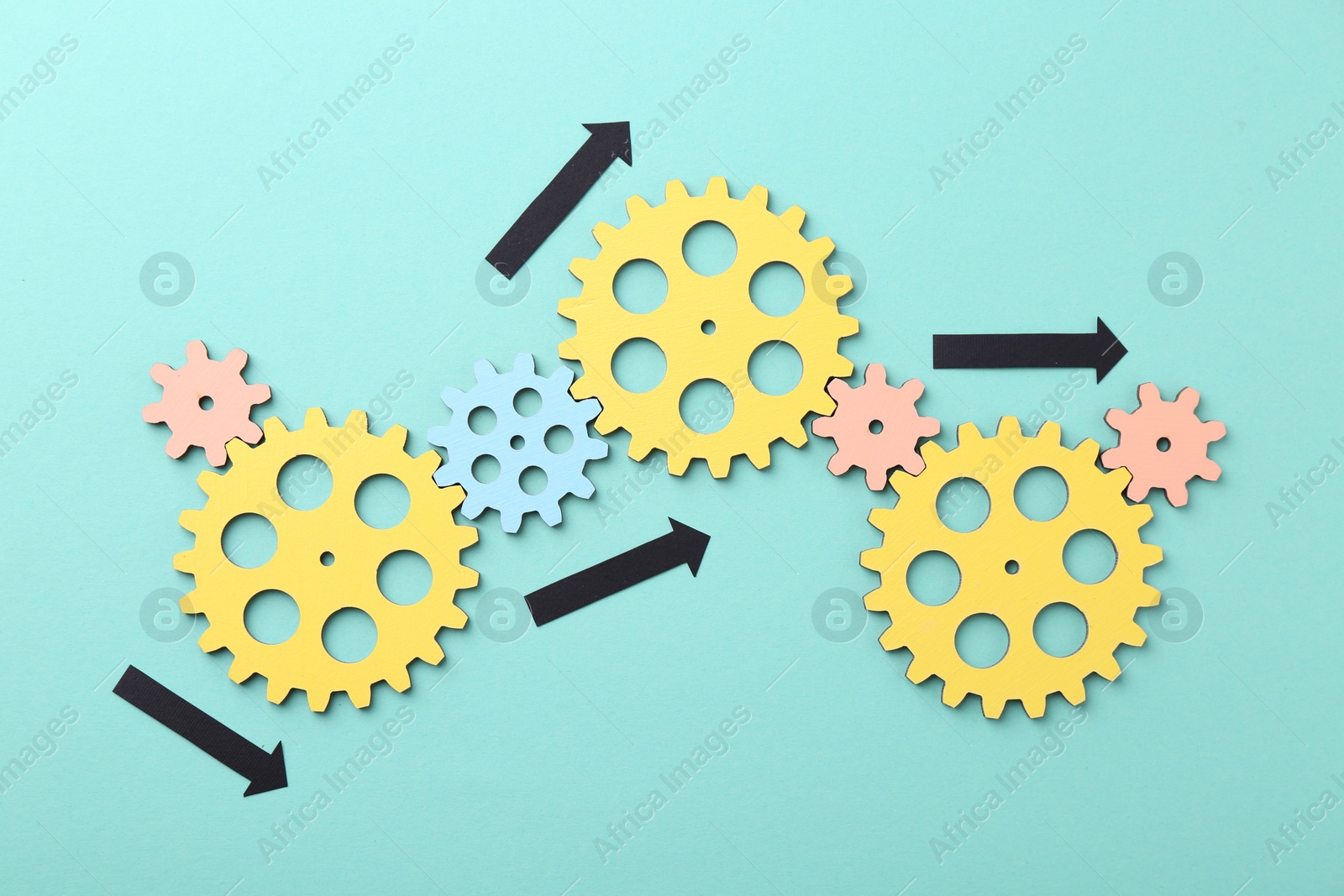 Photo of Business process organization and optimization. Scheme with wooden figures and arrows on light blue background, top view