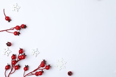 Winter composition with decorative branches on white background, top view
