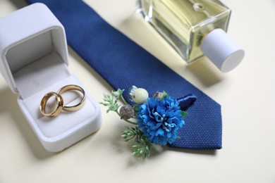 Photo of Wedding stuff. Composition with stylish boutonniere on light background, closeup