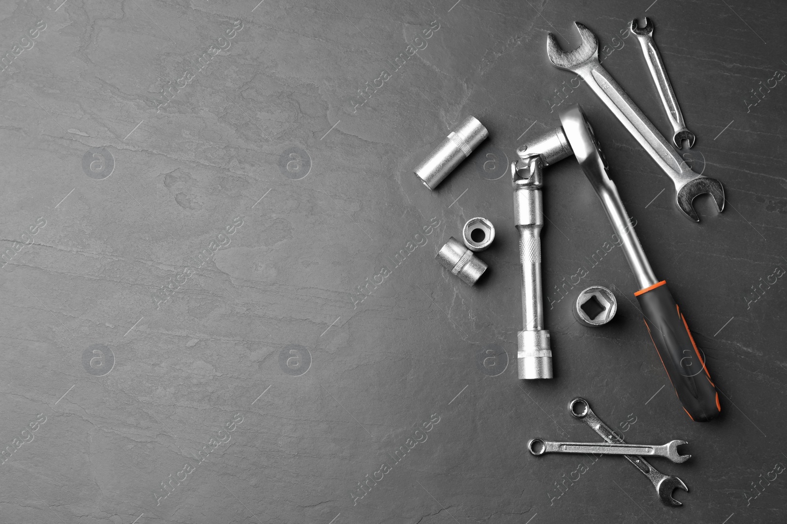 Photo of Auto mechanic's tools on grey background, flat lay. Space for text