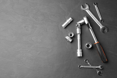Photo of Auto mechanic's tools on grey background, flat lay. Space for text