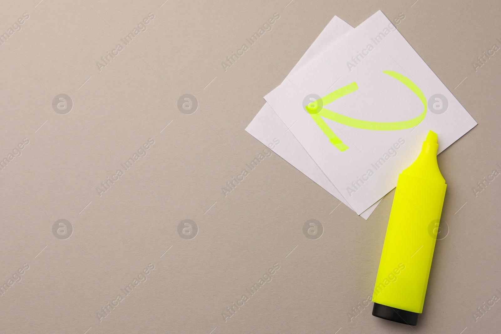 Photo of Bright yellow marker and sticky note with drawn arrow on light grey background, flat lay. Space for text