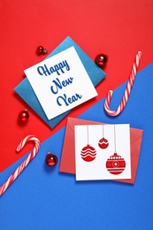 Image of Flat lay composition with greeting cards and Christmas decor on color background. Happy New Year