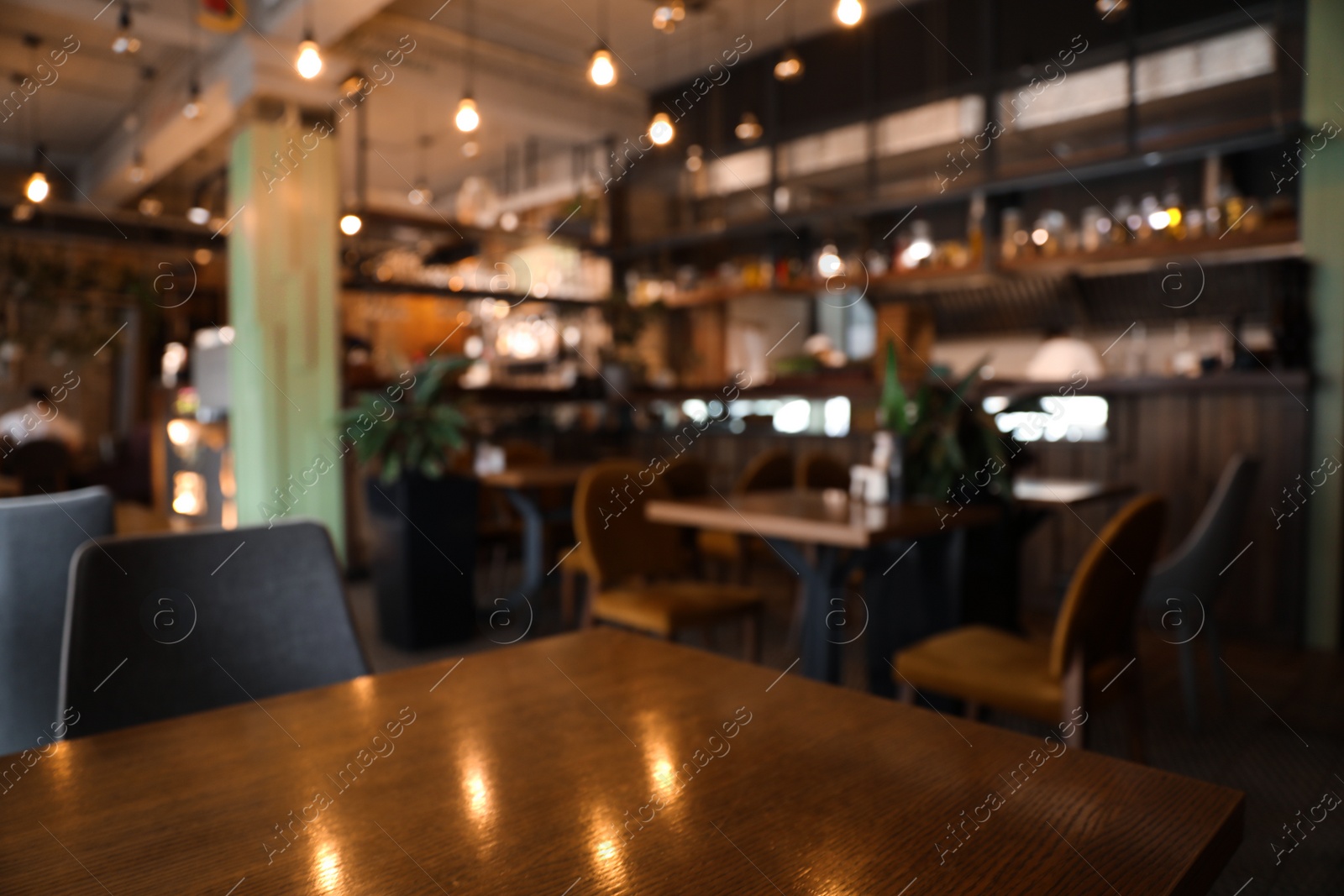 Photo of Blurred view of stylish modern cafe interior with bokeh effect