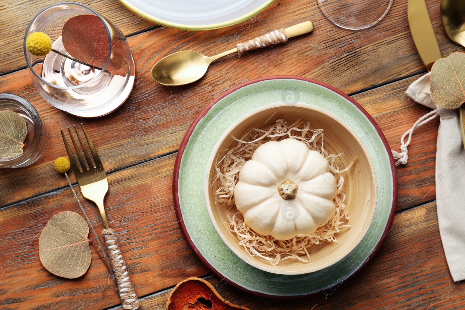 Photo of Autumn table setting with pumpkin and decor on wooden background, flat lay