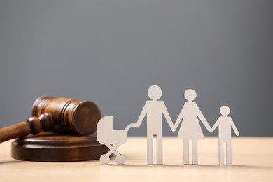Photo of Family law. Figure of parents with children and gavel on wooden table