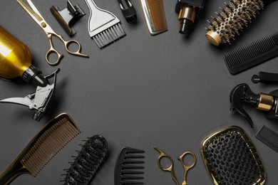 Photo of Frame of hairdressing tools on dark background, flat lay. Space for text