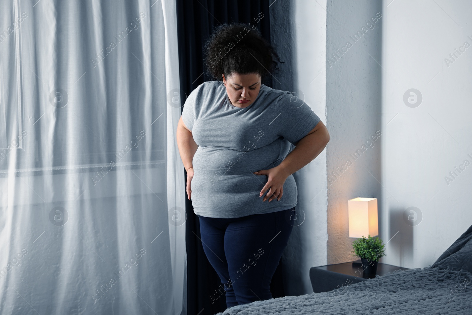 Photo of Overweight woman suffering from depression at home