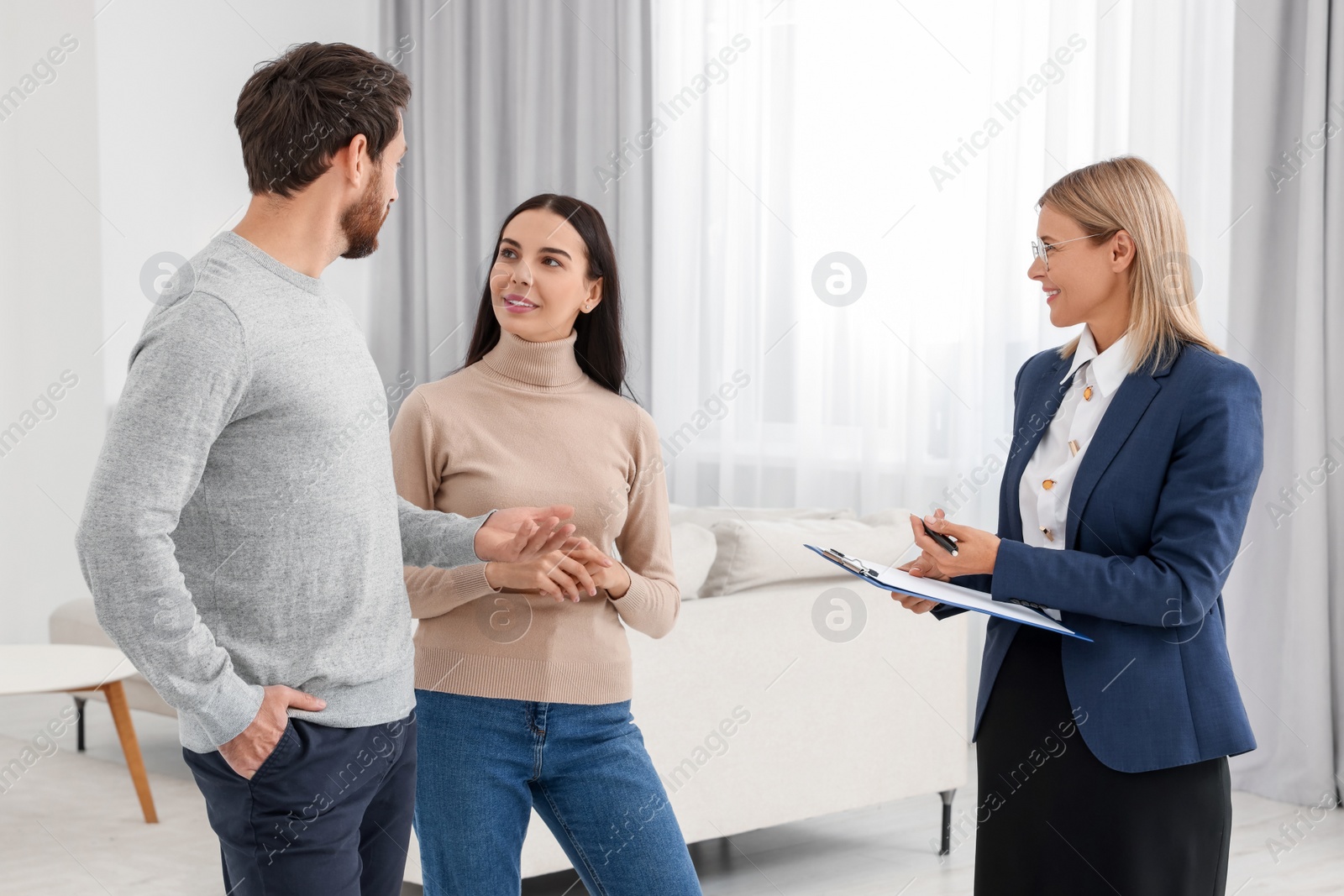 Photo of Real estate agent showing new apartment to couple