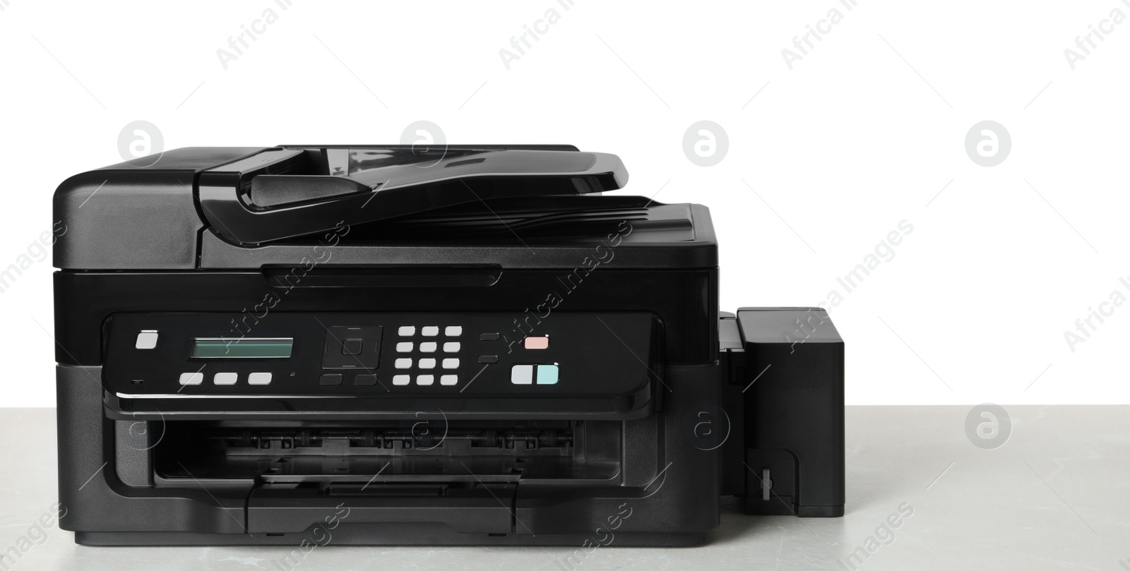Photo of New modern multifunction printer on light table