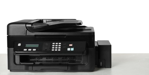 Photo of New modern multifunction printer on light table