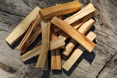 Photo of Palo santo sticks on wooden table, top view