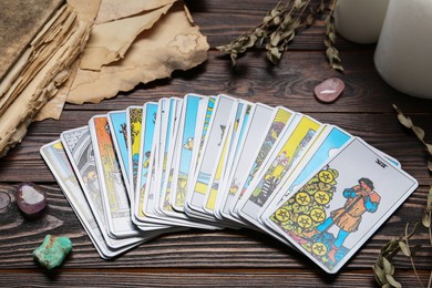 Photo of Tarot cards and crystals on wooden table
