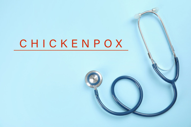 Stethoscope on light blue background, top view. Chickenpox disease 