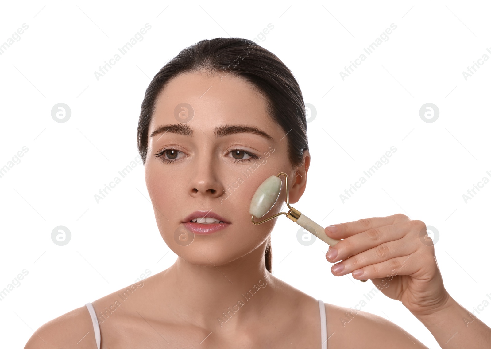 Photo of Young woman massaging her face with jade roller on white background