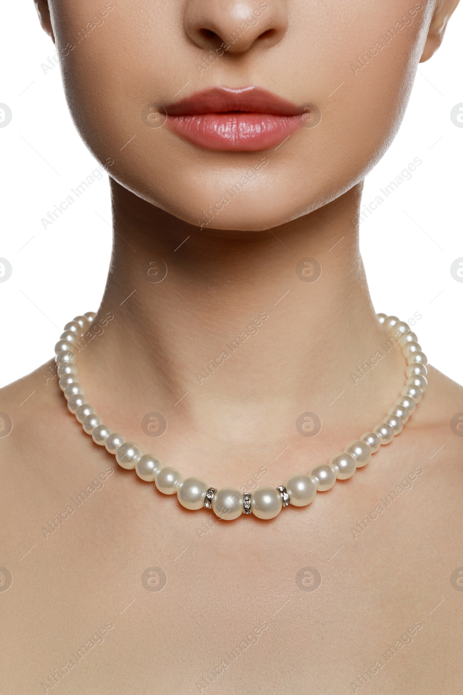 Photo of Young woman wearing elegant pearl necklace on white background, closeup