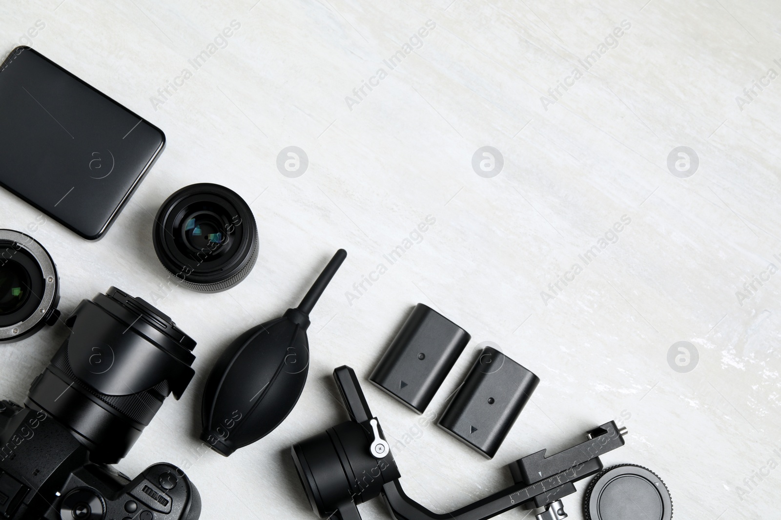 Photo of Camera and video production equipment on light background, flat lay. Space for text