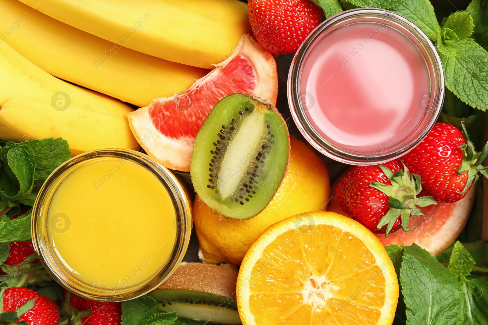 Photo of Glasses with tasty juices and ingredients, top view