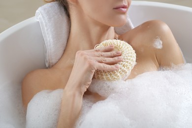 Photo of Woman with sponge taking bubble bath, closeup