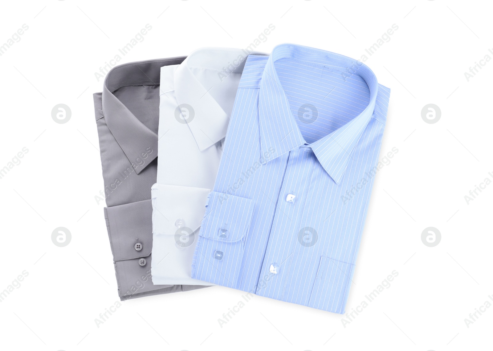 Photo of Stylish shirts isolated on white, top view. Dry-cleaning service