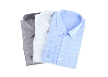 Photo of Stylish shirts isolated on white, top view. Dry-cleaning service