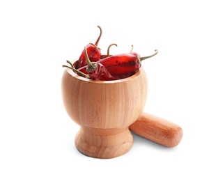 Photo of Wooden mortar with dry chili peppers on white background