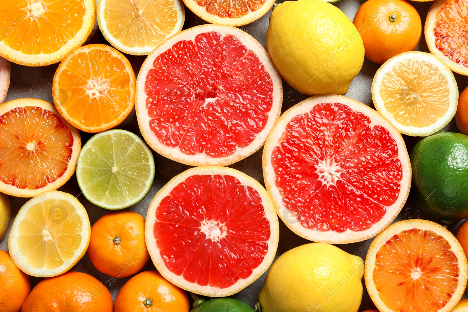 Photo of Different citrus fruits as background, top view