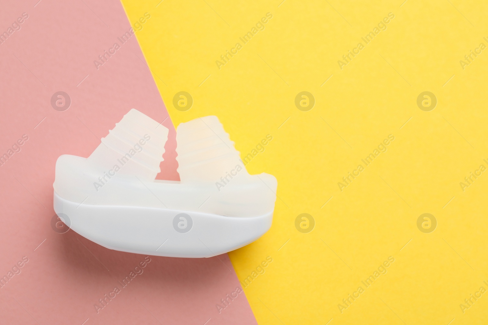 Photo of Nasal anti-snoring device on color background, top view. Space for text