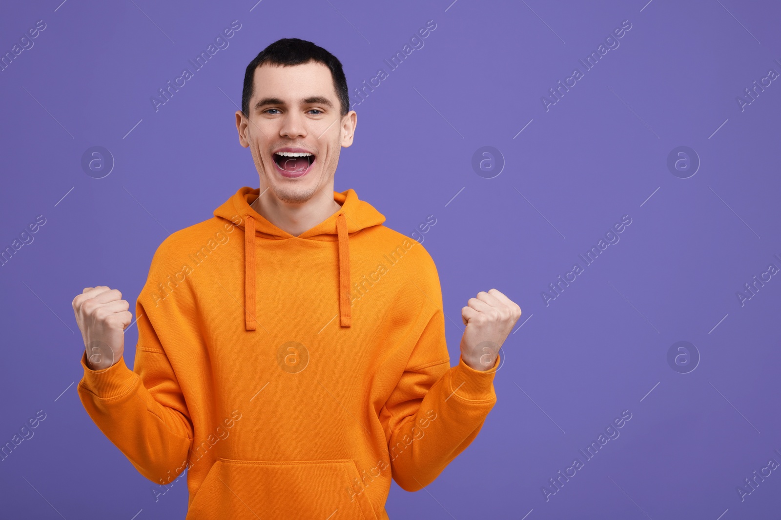 Photo of Portrait of surprised man on purple background, space for text