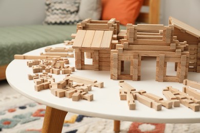 Wooden construction set on white table indoors. Children's toy