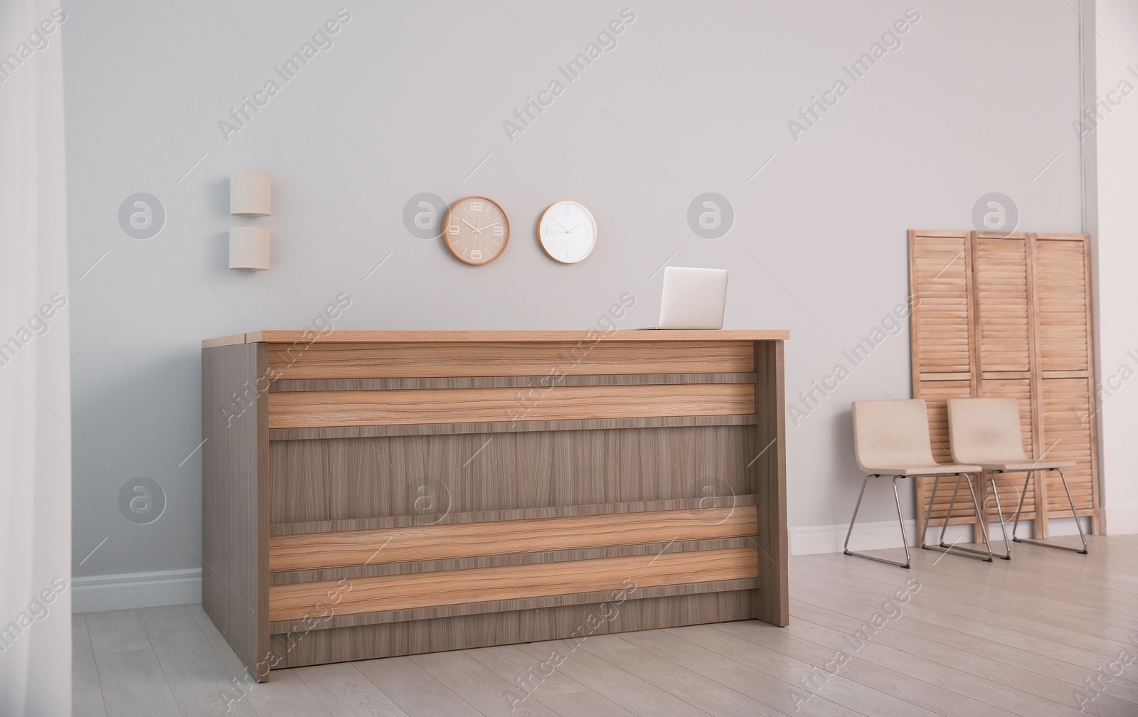 Photo of Hotel lobby interior with wooden reception desk