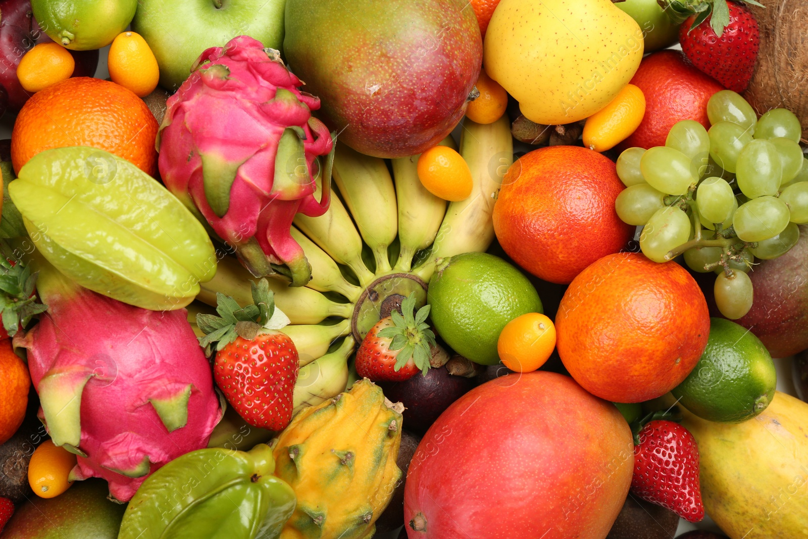 Photo of Assortment of fresh exotic fruits as background, top view