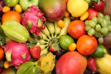 Photo of Assortment of fresh exotic fruits as background, top view