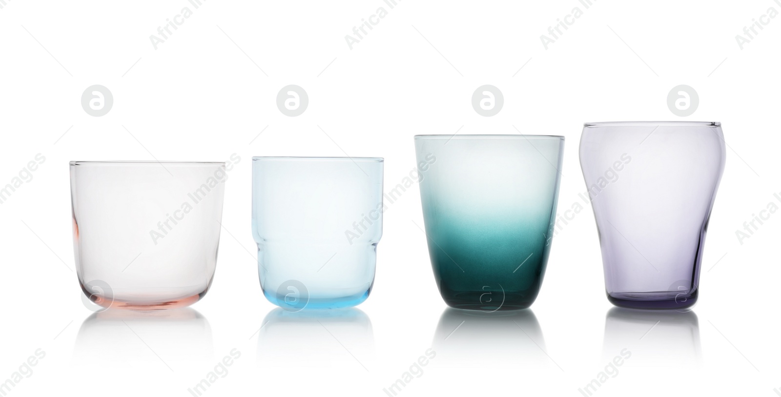 Photo of Row of colorful empty glasses isolated on white