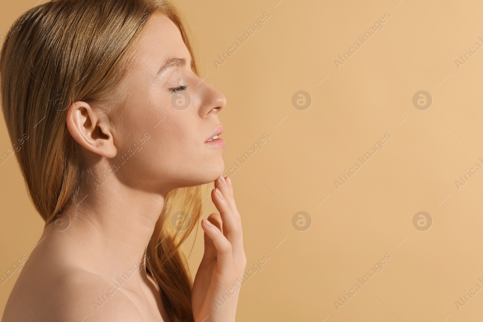 Photo of Beautiful young woman posing on beige background, space for text