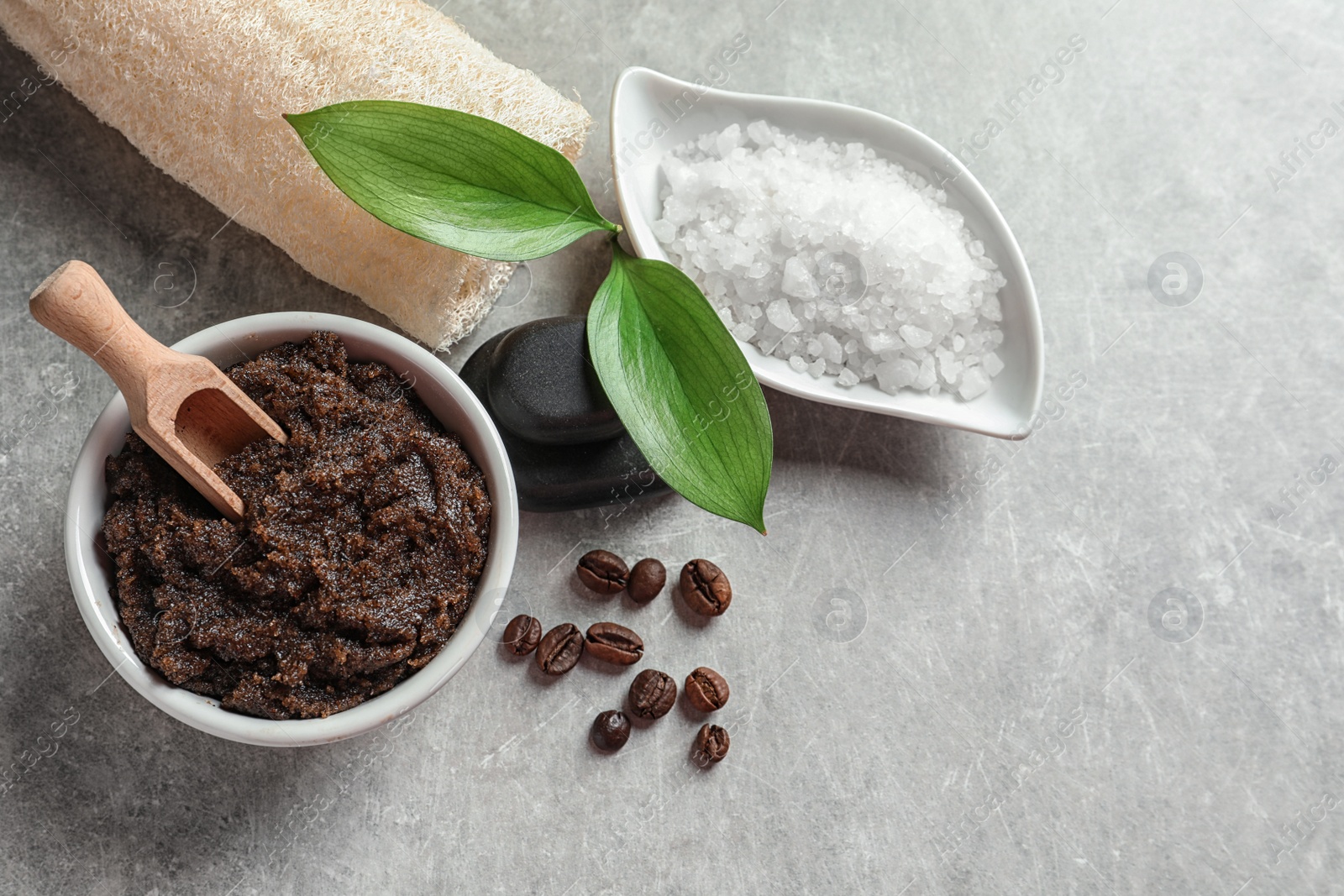 Photo of Bowl of coffee scrub with scoop on table