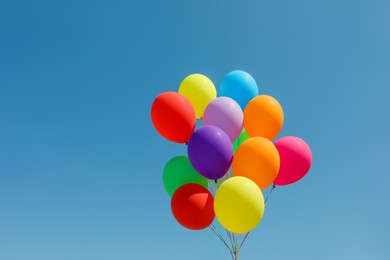 Bunch of colorful balloons against blue sky