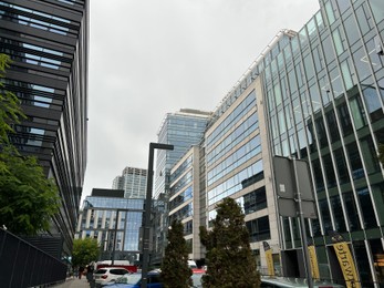 Photo of WARSAW, POLAND - JULY 11, 2022: Low angle view of modern buildings on city street