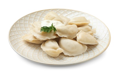 Photo of Plate of tasty dumplings with sour cream and parsley isolated on white