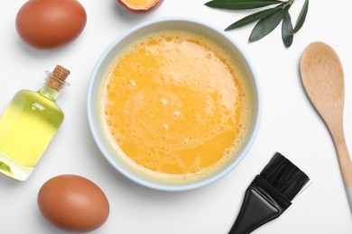 Homemade hair mask, brush and ingredients on white background, flat lay