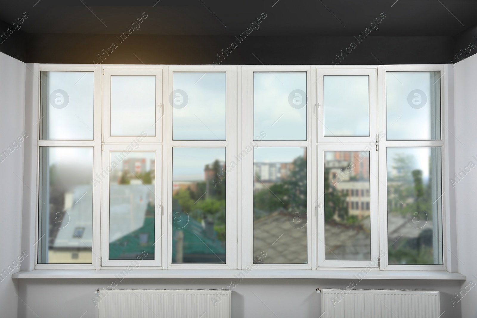 Photo of Beautiful view of cityscape through white windows