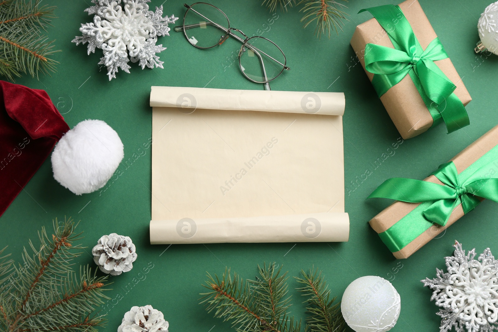 Photo of Flat lay composition with blank sheet of paper on green background, space for text. Writing letter to Santa