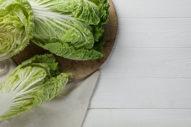 Photo of Fresh ripe Chinese cabbages on white wooden table, flat lay. Space for text